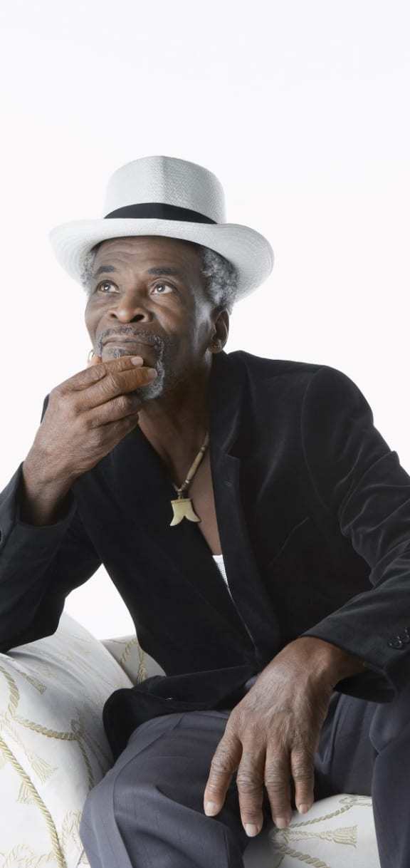 Man Sitting on Chair Wearing Hat