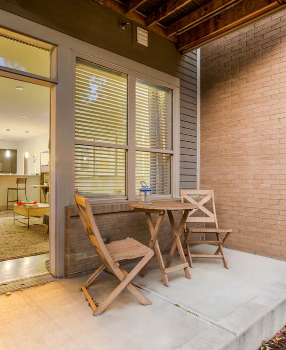 a patio with a table and chairs on it