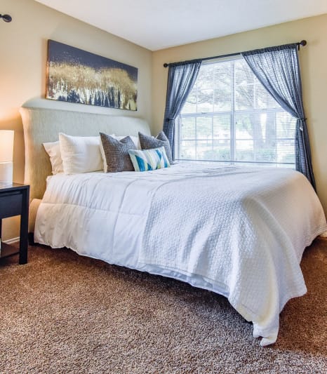 a bedroom with a large bed and a window at Riverset Apartments, Memphis, 38103
