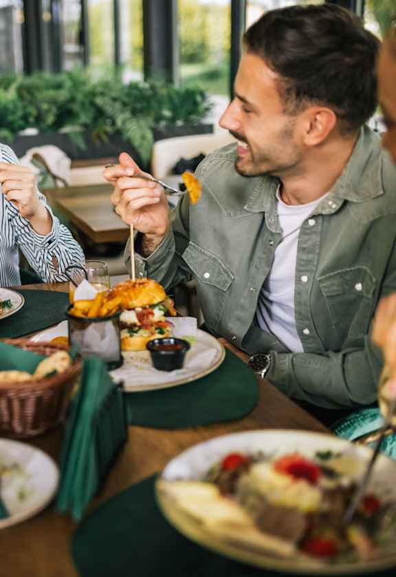 A group of people enjoying a meal together at a restaurant.