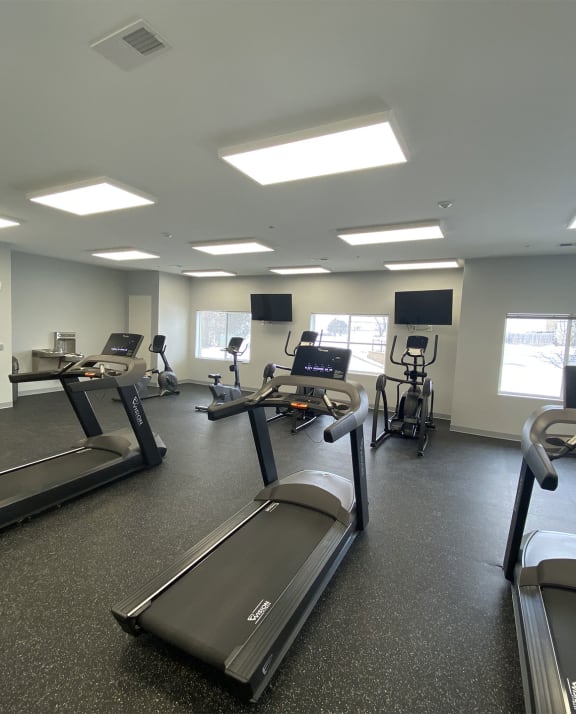 apartment property fitness room with treadmills and exercise bikes