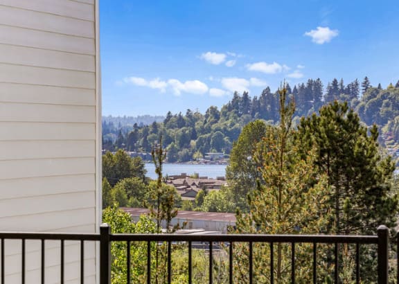 a balcony with a view of a city and a river