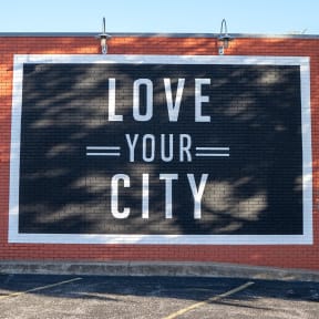 a mural on the side of a building that says love your city
