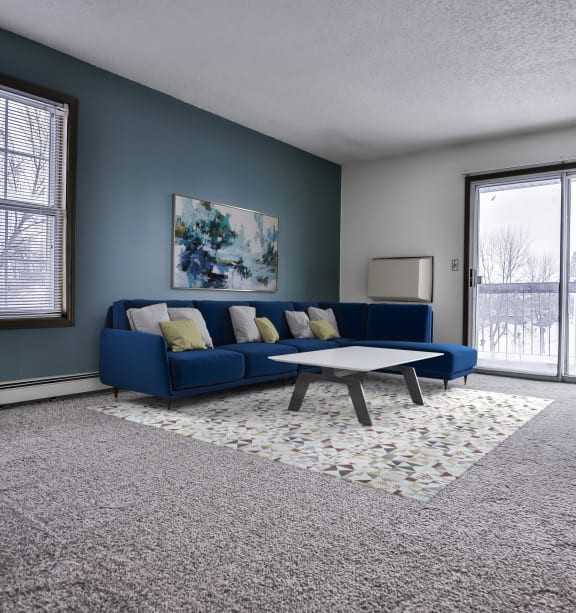 a living room with a blue couch and a coffee table