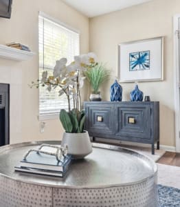 a living room with a fireplace and a round table