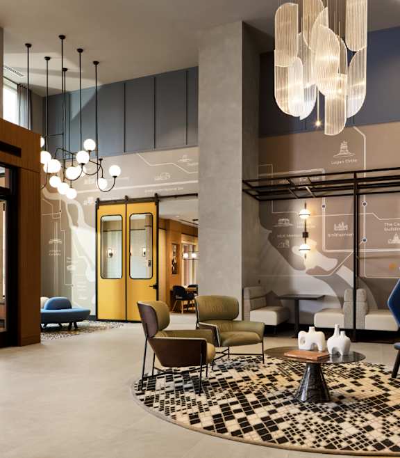a lobby with a reception desk and a large gallery of flowers on the wall