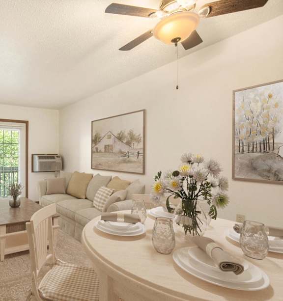 A dining room with a table set for two and a ceiling fan.