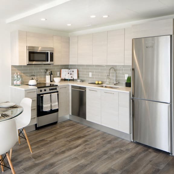a kitchen and dining room with a table and chairs at 1305 Dock Street, Maryland, 21231
