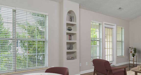 A living room with a white table and red chairs at The Orchard, Dublin, OH