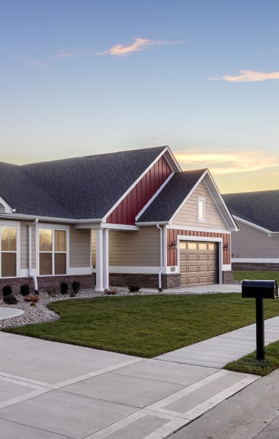 a row of houses with garage doors and a driveway