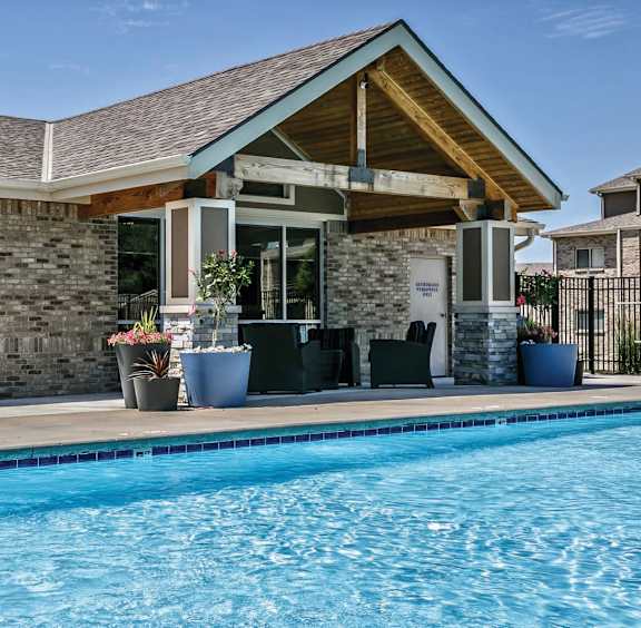 A pool in front of a building with a sign that says "OPEN".