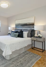 a bedroom with a large bed and a desk with a chair