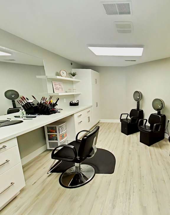 A person is cutting hair with scissors and a comb.