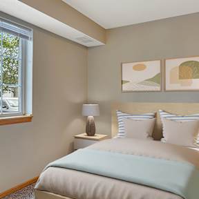 a bedroom with a bed and a large window