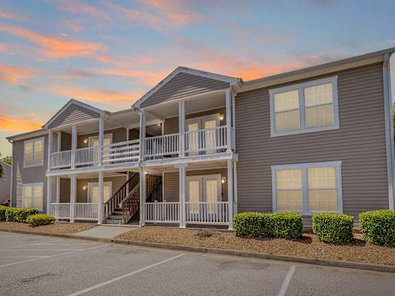 a patio with a green couch and a view of the sky lounge at Sanctuary Apartments & Townhomes, Augusta
