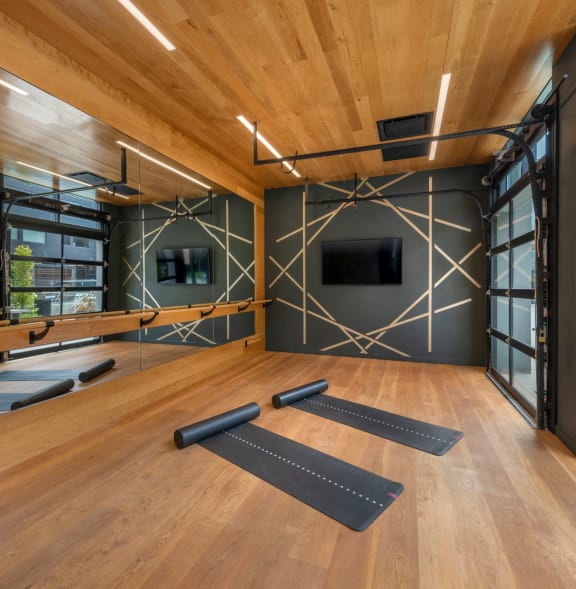 a yoga room with yoga mats and a television on the wall at The Audubon New Haven, New Haven, 06511
