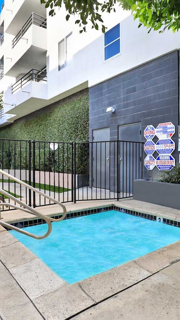 A garden with a curved path and a lamp post at Midvale Towers Apartments Westwood, California 90024