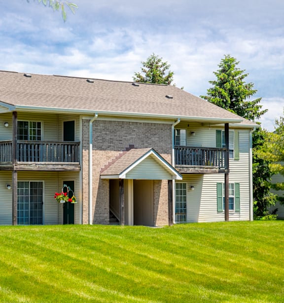 A two-story house with a balcony on the second floor.