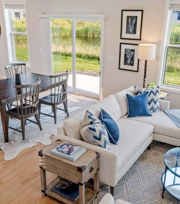 A living room with a white couch and a wooden coffee table.