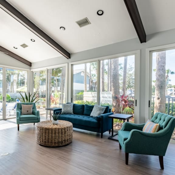 a living room with blue couches and chairs and a fireplace