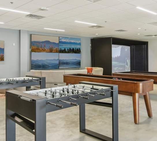 a conference room with tables and chairs and paintings on the wall