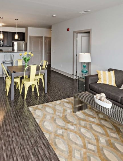 a living room and kitchen with a couch and a table