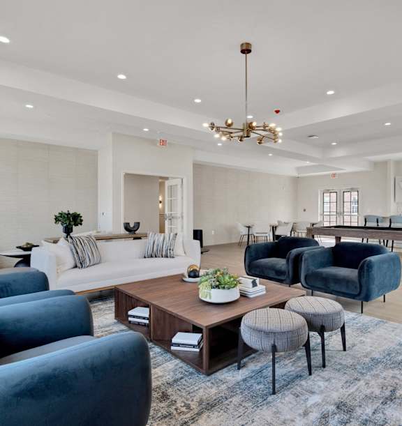 A living room with a large blue sofa and a coffee table.