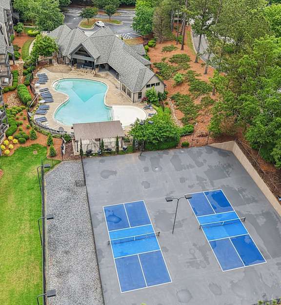 an aerial view of a tennis court on a blue court