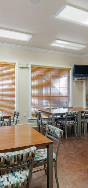 A dining room with a wooden table and chairs.