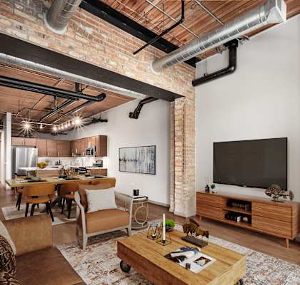 A living room with a brick wall and a television.