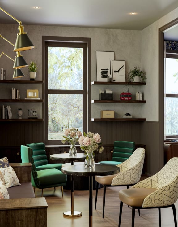 a living room with green chairs and a coffee table