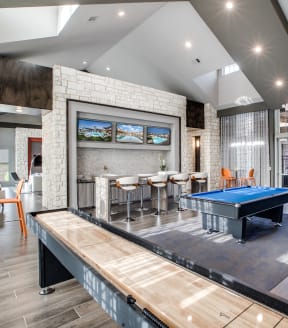 a game room with a pool table and a ping pong table