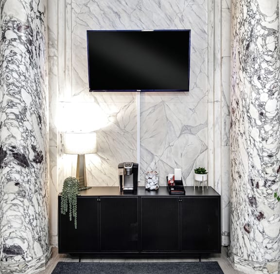 a living room with a tv and a black and white wall
