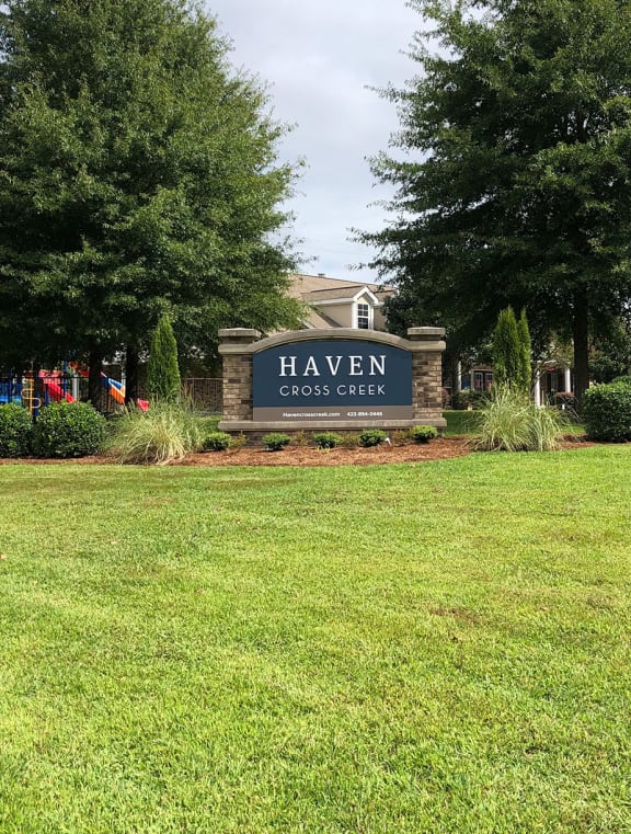 a large lawn in front of a building with a sign that says hawken community center