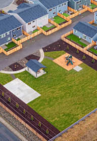 A bird's eye view of a neighborhood with houses and a playground.