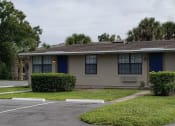Thumbnail 3 of 21 - a house with a blue door and a lawn
