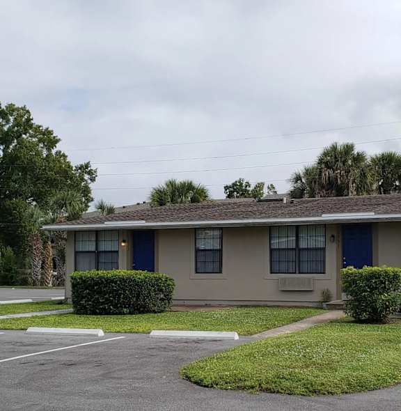 a house with a blue door and a lawn