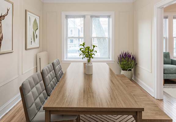 a dining room with a table and chairs