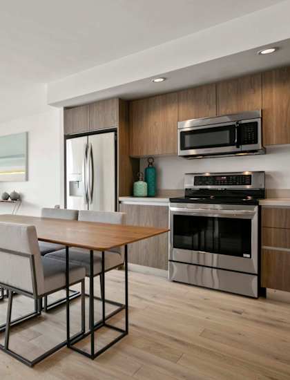 A modern kitchen with a dining table and chairs. at The View, Los Angeles, CA, 90005