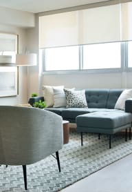 a living room with a couch and two chairs