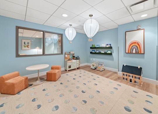 A room with a blue wall and a white ceiling with a light fixture.