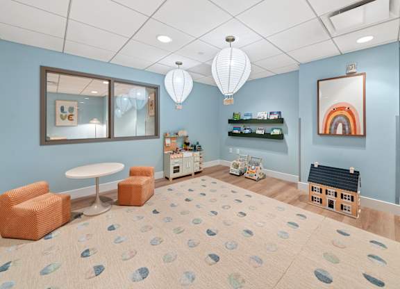 A room with a blue wall and a white ceiling with a light fixture.