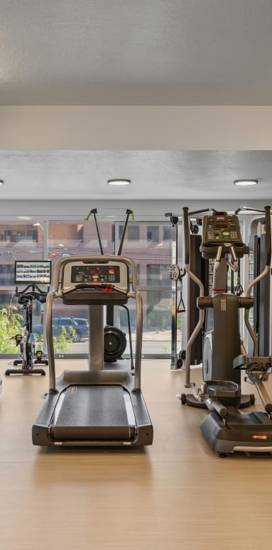 a gym full of exercise bikes and a tv at Paperbox Lofts, Salt Lake City, UT, 84101