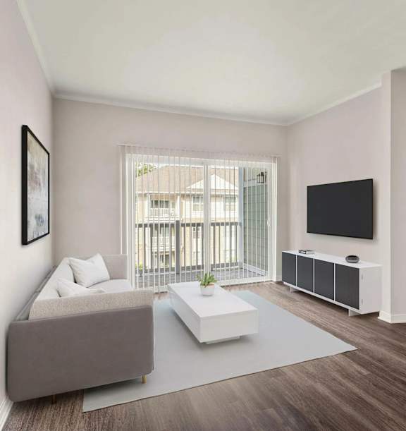 A living room with a grey sofa, a white coffee table, a flat screen TV and a window with a view of a balcony.