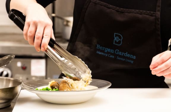 a chef prepares a dish in a kitchen