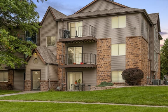 our apartments have a spacious yard with green grass and trees