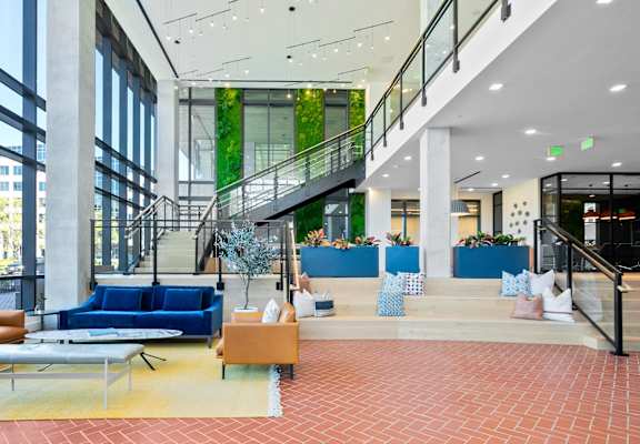 the lobby of an office building with couches and chairs