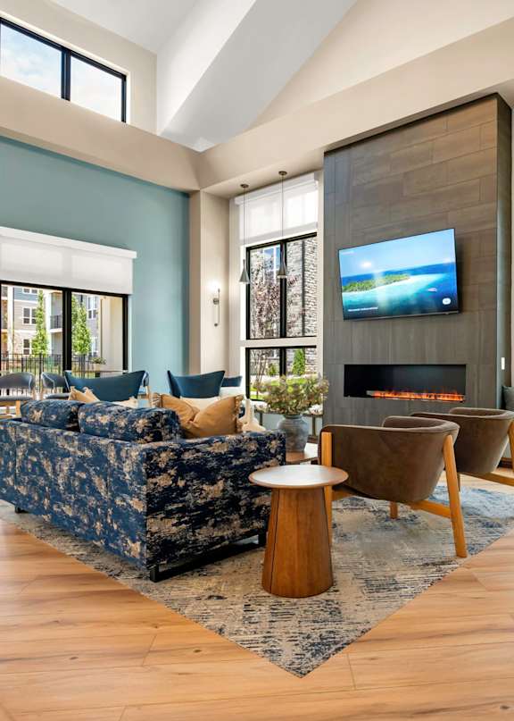 A modern living room with a large couch and a fireplace.