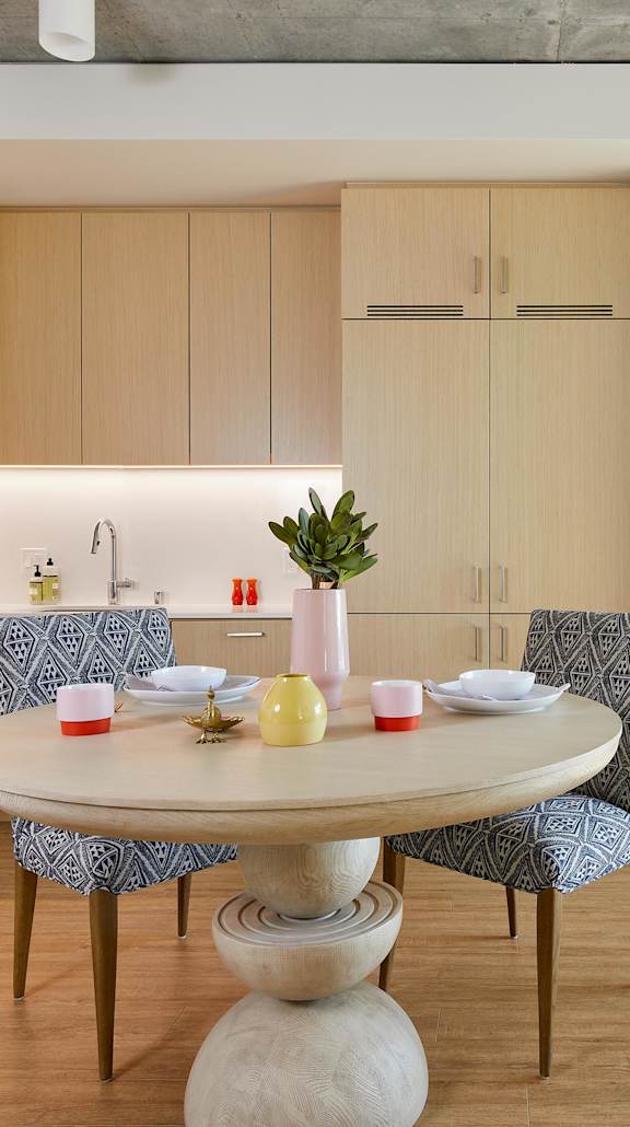 A modern kitchen with a round table and chairs.