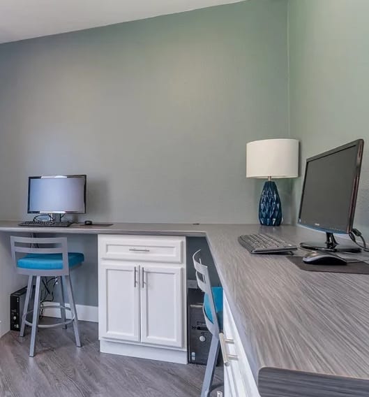 Resident Business Center with two computers and chairs at Spring Meadow Apartments in Glendale, Arizona